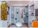 Well-organized walk-in closet with custom shelving, drawers, and ample storage at 9380 Sw 84Th Ter # E, Ocala, FL 34481