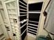 Functional closet with custom storage solutions including a jewelry organizer behind door at 9380 Sw 84Th Ter # E, Ocala, FL 34481