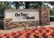 Stone community sign for 'On Top of the World' surrounded by colorful ground cover at 9380 Sw 84Th Ter # E, Ocala, FL 34481