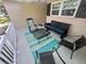 Cozy front porch with rocking chair, bench, table and decorative rug at 9380 Sw 84Th Ter # E, Ocala, FL 34481