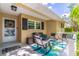 Inviting front porch with seating area, a welcome mat and a decorative wreath at 9380 Sw 84Th Ter # E, Ocala, FL 34481