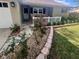 Landscaped front yard with decorative stone and brick borders, plants and small porch at 9380 Sw 84Th Ter # E, Ocala, FL 34481