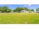 Wide view of expansive green lawn and houses of a well-kept community at 9380 Sw 84Th Ter # E, Ocala, FL 34481