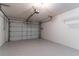 Spacious garage with epoxy floors, overhead lighting, and wall-mounted shelving at 9380 Sw 84Th Ter # E, Ocala, FL 34481
