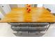 Spacious kitchen island with light wood top, gray cabinets, and copper hardware at 9380 Sw 84Th Ter # E, Ocala, FL 34481