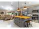 Open kitchen and living room area with gray cabinets, stainless steel appliances, and butcher block island at 9380 Sw 84Th Ter # E, Ocala, FL 34481
