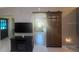 Living room features stylish barn door, TV, and cozy fireplace, perfect for relaxing at 9380 Sw 84Th Ter # E, Ocala, FL 34481