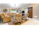 Bright living room featuring a large sectional sofa, ceiling fan, and barn door at 9380 Sw 84Th Ter # E, Ocala, FL 34481