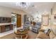Comfortable living area showcasing a vaulted ceiling, updated lighting, and a view of the kitchen at 9380 Sw 84Th Ter # E, Ocala, FL 34481