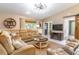 Spacious living room featuring a large sectional sofa, ceiling fan, and barn door at 9380 Sw 84Th Ter # E, Ocala, FL 34481