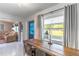 Bright office with a large window, wooden desk, and custom cabinets, offering a pleasant workspace at 9380 Sw 84Th Ter # E, Ocala, FL 34481