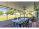 Covered and screened patio features ceiling fan, table and chairs at 9380 Sw 84Th Ter # E, Ocala, FL 34481
