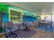 Lanai features tiled floor, patio seating and coastal mural at 9380 Sw 84Th Ter # E, Ocala, FL 34481