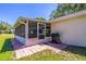 View of screened porch with access to outdoor patio and grill, perfect for outdoor cooking at 9380 Sw 84Th Ter # E, Ocala, FL 34481