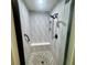 Walk-in shower features eye-catching decorative tile and sleek black shower fixtures at 9380 Sw 84Th Ter # E, Ocala, FL 34481