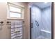 Stylish shower with glass door, decorative tile, bench, and modern fixtures at 9380 Sw 84Th Ter # E, Ocala, FL 34481