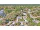 Aerial view of the property showcasing the home's location in a lush, tree-filled neighborhood at 9844 Sw 198Th Cir, Dunnellon, FL 34432
