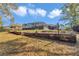 Landscaped backyard featuring a screened pool enclosure and multi-level yard at 9844 Sw 198Th Cir, Dunnellon, FL 34432