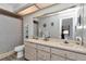 Bathroom featuring double sink vanity, mirror, and shower at 9844 Sw 198Th Cir, Dunnellon, FL 34432