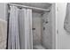 Shower features gray tile with patterned accents, a shower caddy, and safety rail at 9844 Sw 198Th Cir, Dunnellon, FL 34432