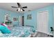 Bedroom with a blue color scheme, ceiling fan and closet at 9844 Sw 198Th Cir, Dunnellon, FL 34432