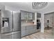 Kitchen featuring stainless steel appliances, granite countertops, mosaic backsplash, and wood grain laminate flooring at 9844 Sw 198Th Cir, Dunnellon, FL 34432