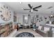 Open living room with ceiling fan, fireplace, seating and decor at 9844 Sw 198Th Cir, Dunnellon, FL 34432