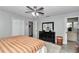 Bedroom featuring dark wood furnishings, ceiling fan and wood grain laminate flooring at 9844 Sw 198Th Cir, Dunnellon, FL 34432