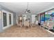 Covered patio with dining table, seating, and tile flooring at 9844 Sw 198Th Cir, Dunnellon, FL 34432