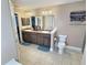 Bathroom featuring a dual sink vanity, a toilet, and decorative wall lighting at 1034 Se 65Th Cir, Ocala, FL 34472