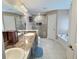 Bright bathroom with tile floors, a shower, a tub, and double sinks at 1034 Se 65Th Cir, Ocala, FL 34472
