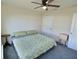 Bedroom with carpeted floors, ceiling fan, and side table at 1034 Se 65Th Cir, Ocala, FL 34472