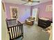 Charming Bedroom with crib, chair, changing table, and sweet decor, creating a comforting space for baby at 1034 Se 65Th Cir, Ocala, FL 34472