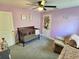 Charming Bedroom with a crib, chair, and butterfly wall decor at 1034 Se 65Th Cir, Ocala, FL 34472