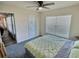 Bedroom with carpeted floors, a window, and door to exterior patio at 1034 Se 65Th Cir, Ocala, FL 34472