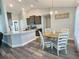 Dining area with a wooden table, views into the kitchen with granite countertops at 1034 Se 65Th Cir, Ocala, FL 34472