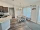 Dining area featuring a wooden table, white chairs, and views into kitchen at 1034 Se 65Th Cir, Ocala, FL 34472