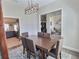 Open dining area with a modern light fixture, table with 6 chairs, and easy access to other rooms at 1034 Se 65Th Cir, Ocala, FL 34472
