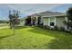 Charming single-Gathering home featuring a well-manicured lawn and cozy front porch at 1034 Se 65Th Cir, Ocala, FL 34472