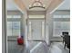 Bright foyer with a decorative lighting fixture and views into the dining area at 1034 Se 65Th Cir, Ocala, FL 34472