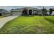 Beautiful single-story home with lush green lawn and manicured landscaping at 1034 Se 65Th Cir, Ocala, FL 34472