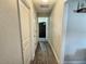 Hallway with wood floors and white walls at 1034 Se 65Th Cir, Ocala, FL 34472
