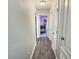 Hallway with wood floors, white walls, and view of Bedroom with crib at 1034 Se 65Th Cir, Ocala, FL 34472