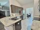 Modern kitchen featuring stainless steel appliances, granite countertops, tile flooring, and dark cabinetry at 1034 Se 65Th Cir, Ocala, FL 34472