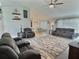 Inviting living room featuring comfortable seating, a ceiling fan, and abundant natural light, perfect for relaxation at 1034 Se 65Th Cir, Ocala, FL 34472