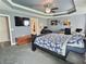Serene main bedroom with dark furniture, tray ceiling, and ample space, creating a comfortable and inviting atmosphere at 1034 Se 65Th Cir, Ocala, FL 34472
