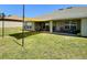 Covered patio includes outdoor seating, a grill, and a sun shade for added comfort at 1034 Se 65Th Cir, Ocala, FL 34472