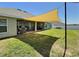 Covered patio featuring outdoor seating, grill, and shade, creating a relaxing outdoor space at 1034 Se 65Th Cir, Ocala, FL 34472