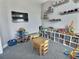 Fun and organized play room with mounted TV and toy storage for creative play and entertainment at 1034 Se 65Th Cir, Ocala, FL 34472