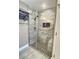 Stylish shower with marble-look tile, a built-in bench and glass enclosure at 1034 Se 65Th Cir, Ocala, FL 34472